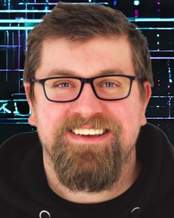 Alexander England, smiling, in glasses and a black hoodie
